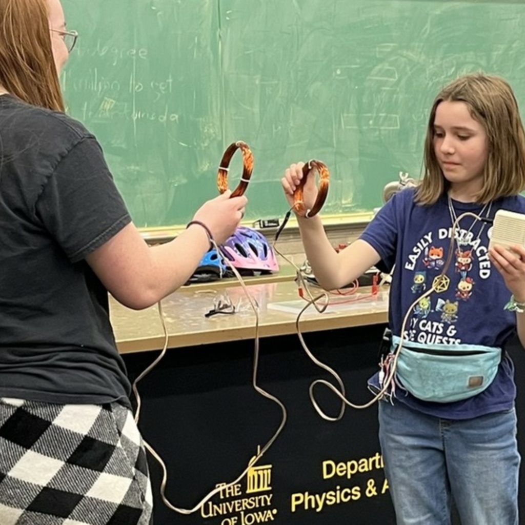 Two children participating in a physics demonstration