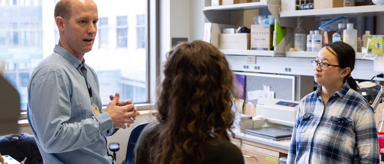 Cancer researcher in the lab with students