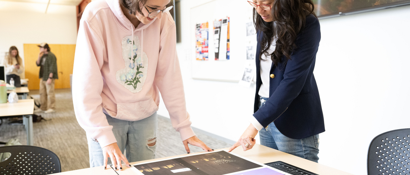 Student and professor working on a graphic design project