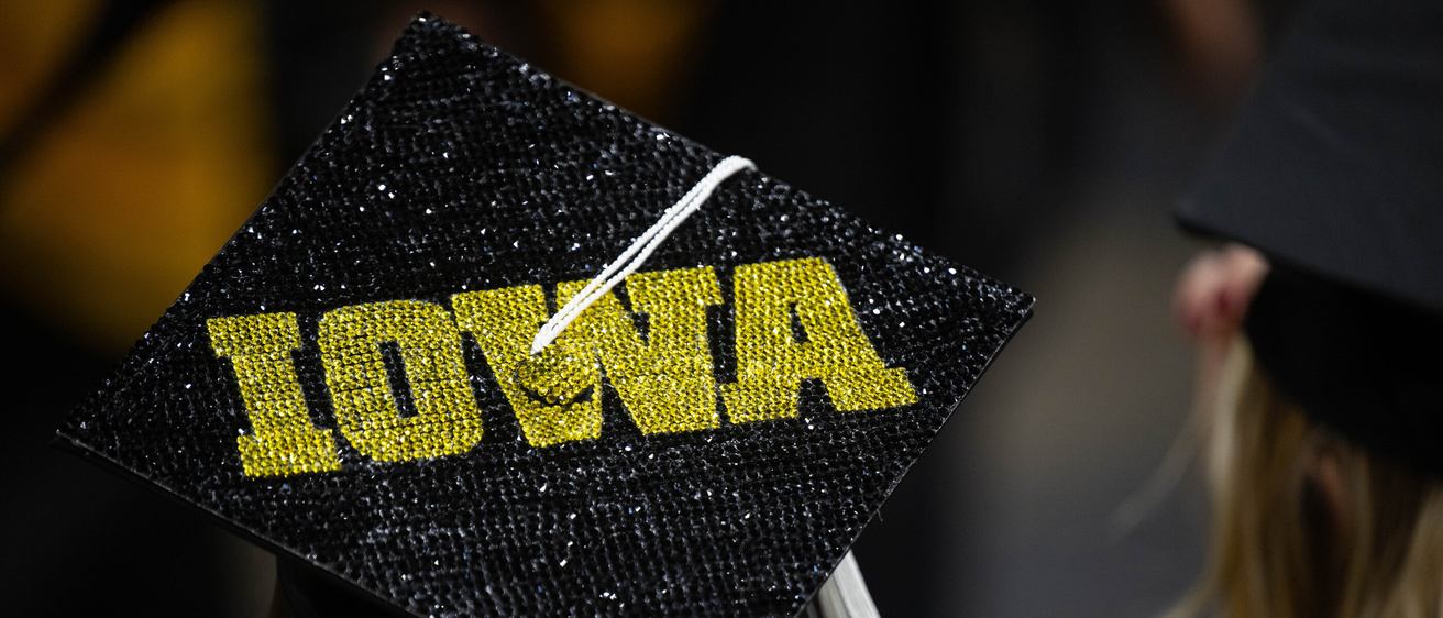 Commencement cap with IOWA in jewels