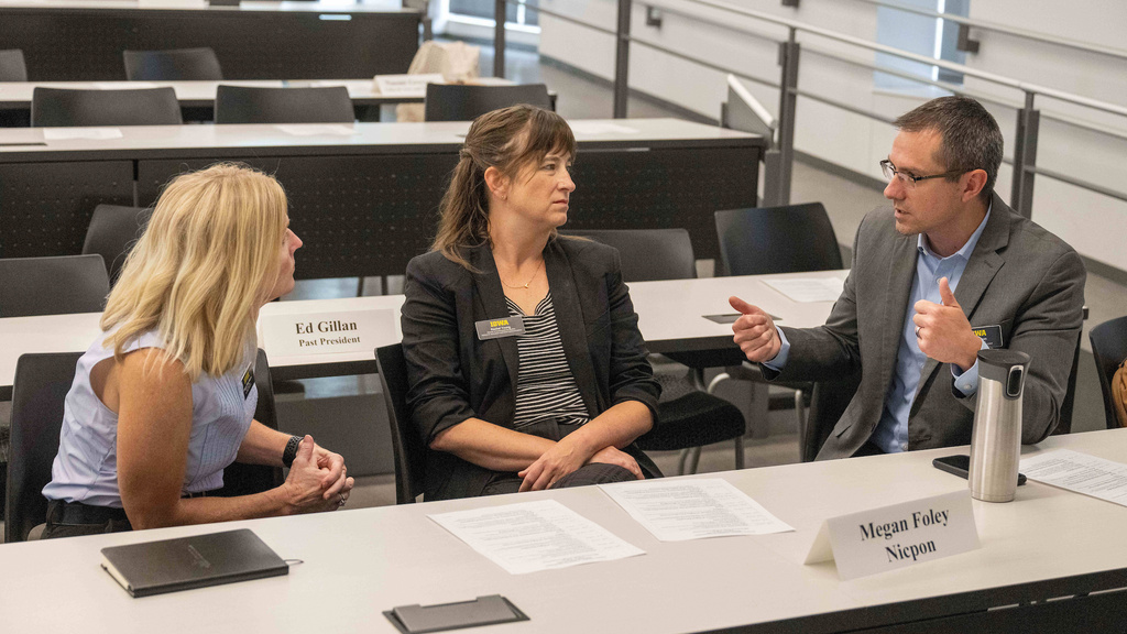 Faculty talking with each other