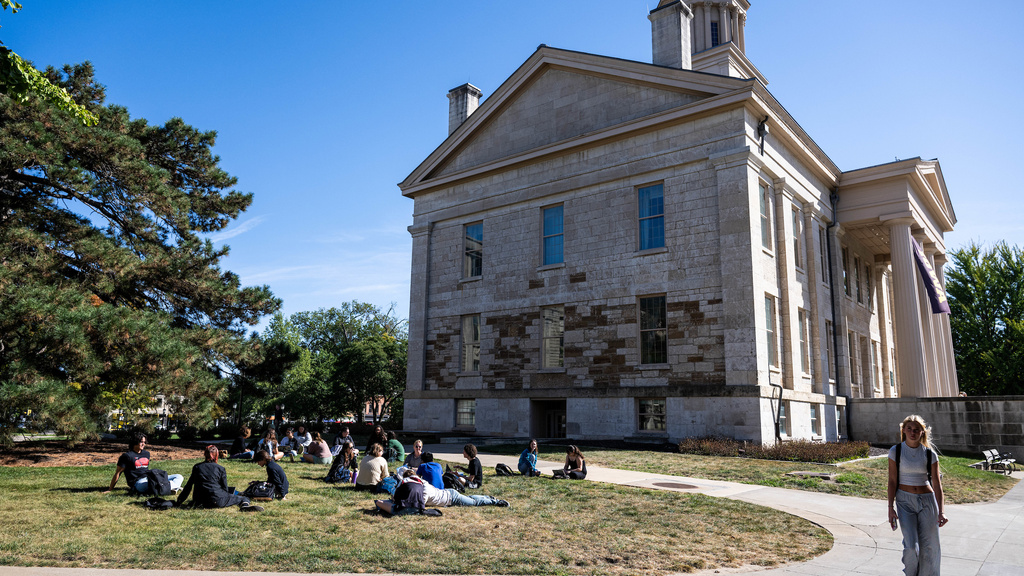 Photo of students sitting on the Pentacrest