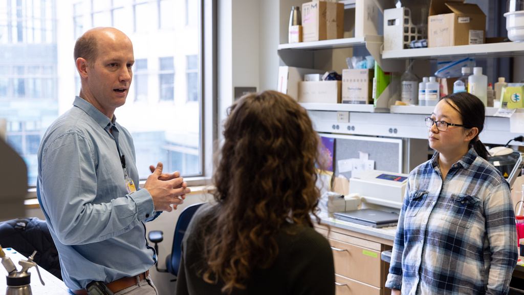 Cancer researcher in the lab with students