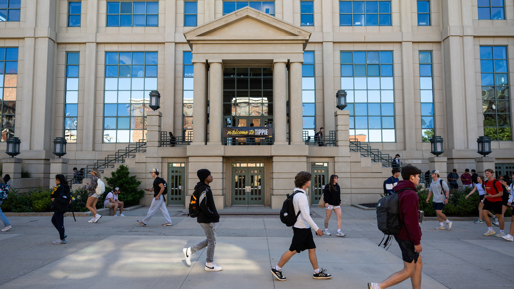 Students walk by the Tippie College of Business building.